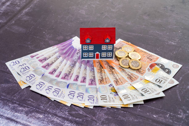 Model house placed on UK currency banknotes