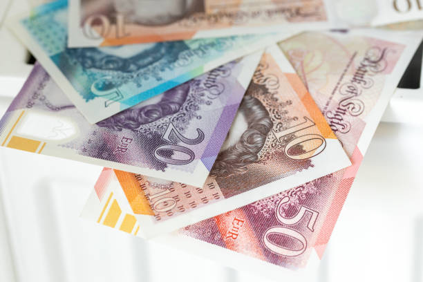 british pounds lying on radiator, Financial concept, household budget, bills expenses in uk, close up